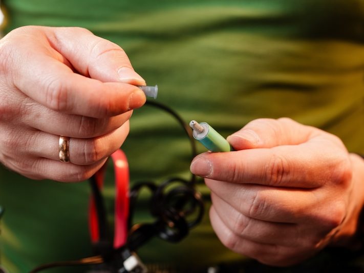 Close up of man repairing computer system unit