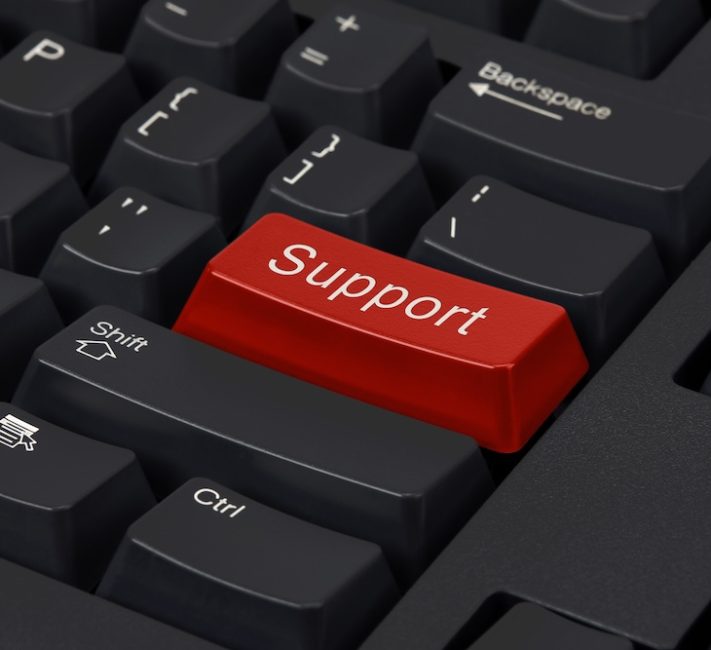 A close-up photo shows a black computer keyboard with a prominent red button labeled 'Support' in white lettering.